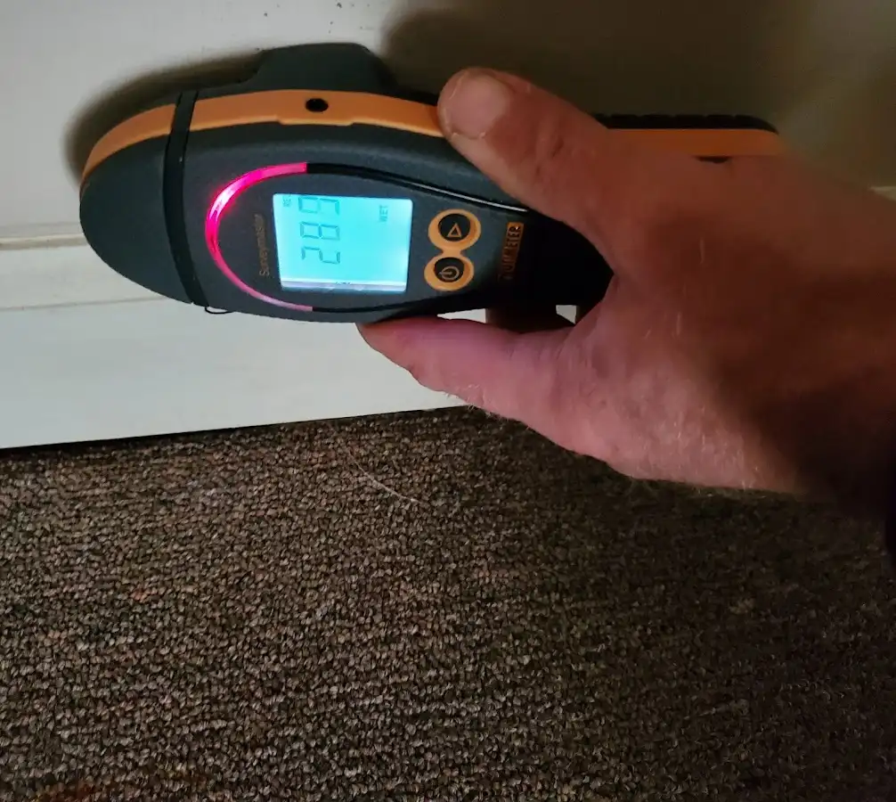 Moisture detection at baseboard during Storm Damage Restoration in Solon